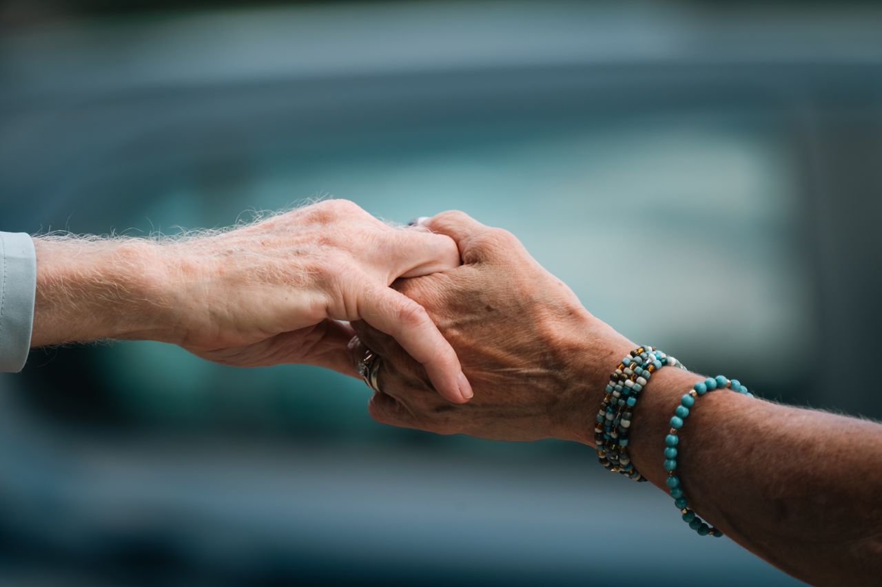 impact-img A heartfelt image of two elderly individuals holding hands, symbolizing love and support.